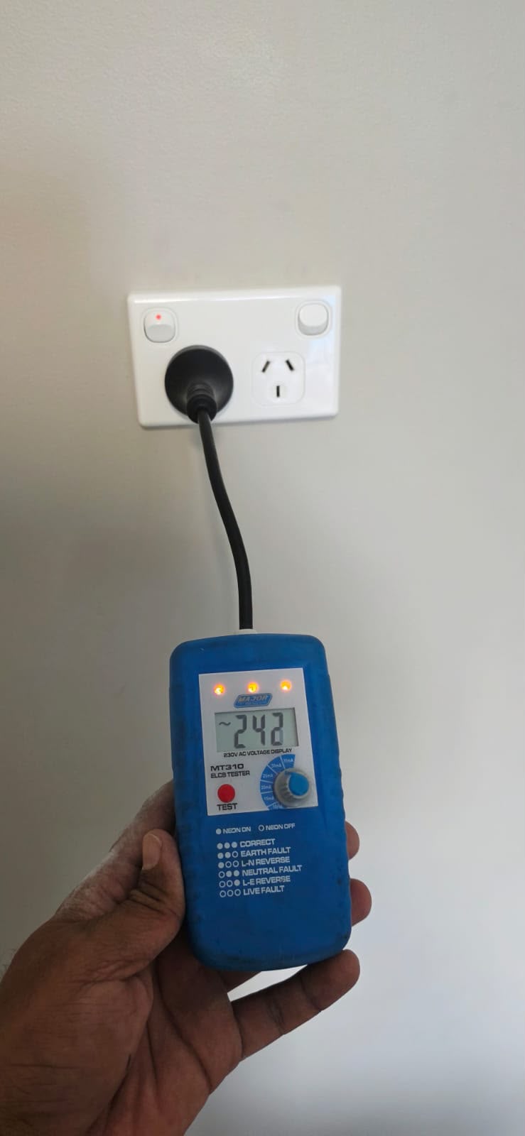 Electrical outlet safety test in progress