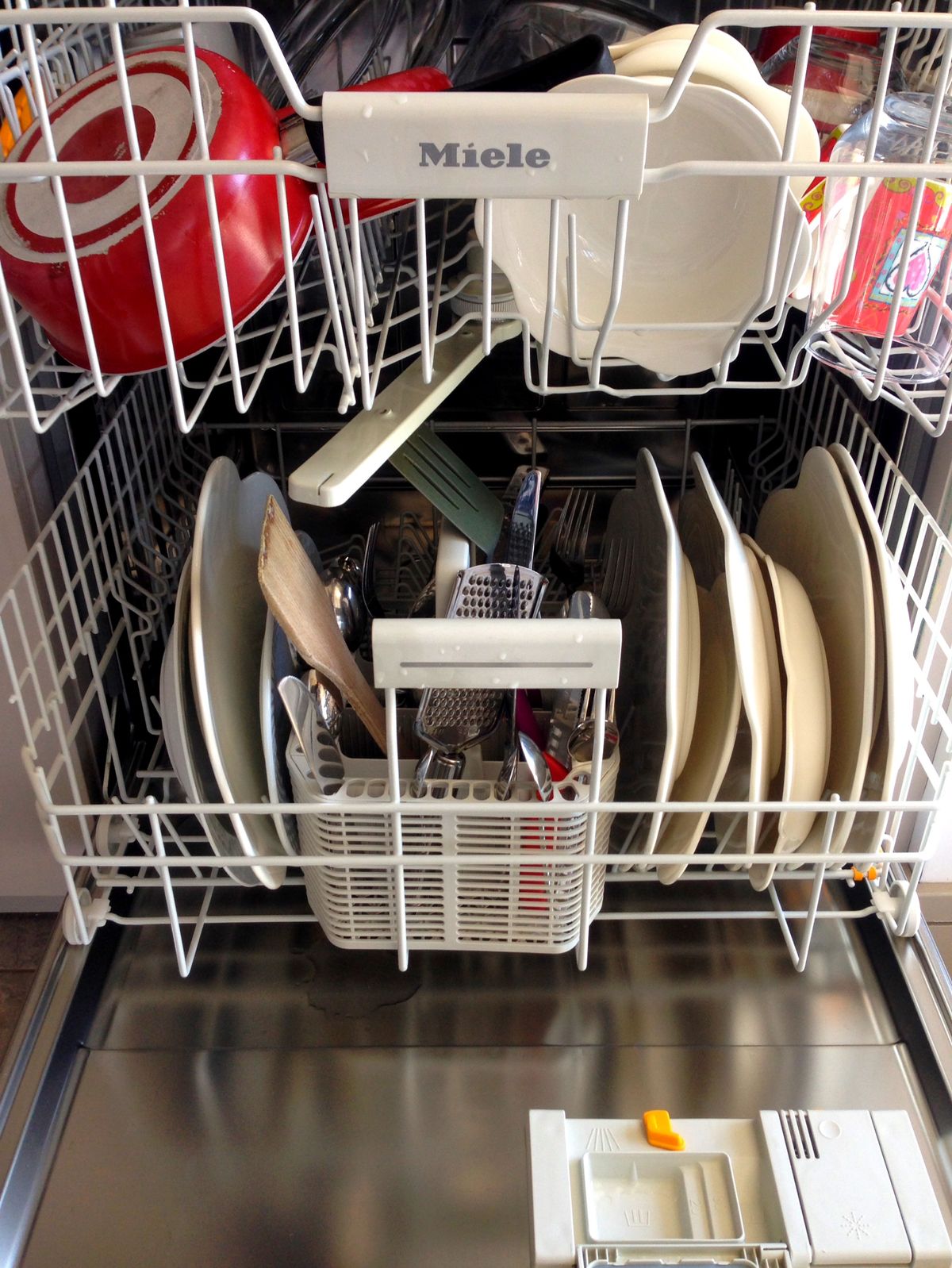 Open dishwasher with dishes