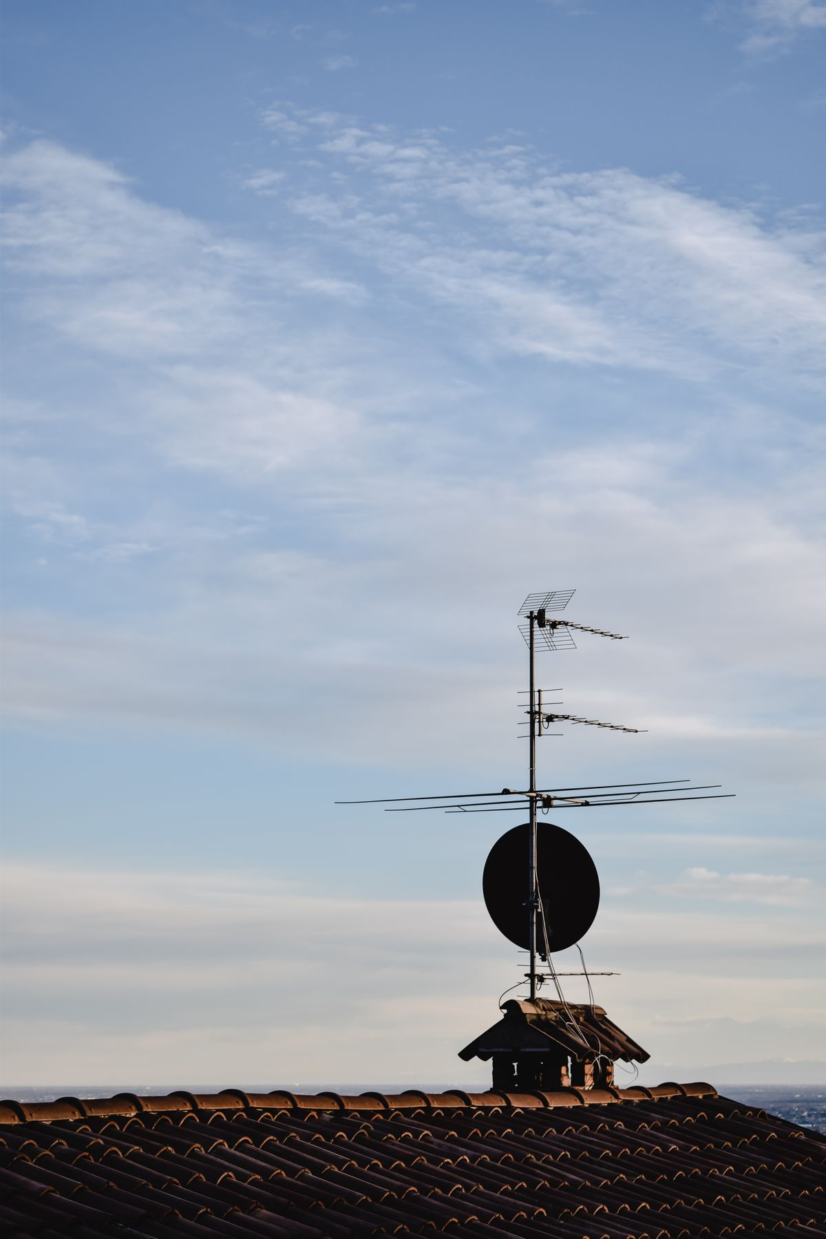 TV antenna and satellite dish on a roof